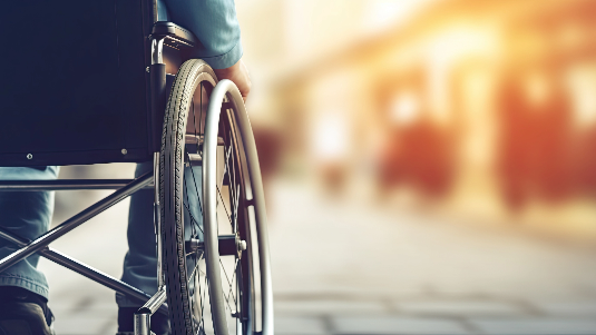 close-up of a man in a wheelchair against a blurred background